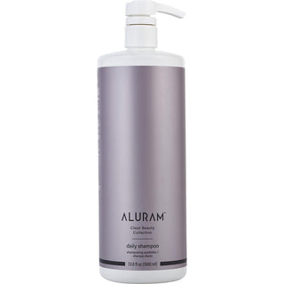 A sleek, 33.8oz bottle of Aluram Clean Beauty Collection Daily Shampoo with a minimalist design, set against a backdrop of botanical elements.