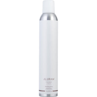 A sleek, 10oz bottle of Aluram Clean Beauty Collection Finishing Spray with a minimalist design, set against a backdrop of botanical elements.