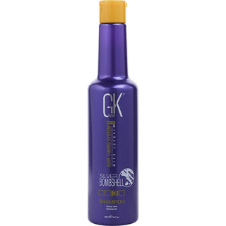 Gk Hair PRO LINE HAIR TAMING SYSTEM WITH JUVEXIN PH+ SHAMPOO 33.8 OZ bottle on a stylish vanity.