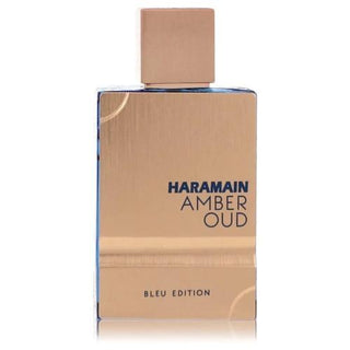 The Al Haramain Amber Oud Bleu Edition Cologne bottle features a woody front and deep blue sides, creating a unique and luxurious design. Available now at FragranceDealz.com.