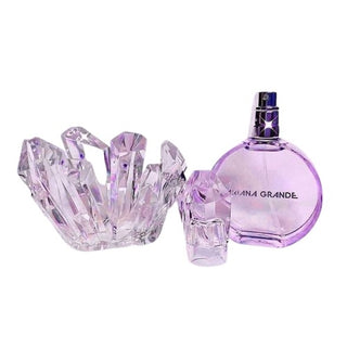 Bottle of Ariana Grande R.E.M. Perfume emerging from crystal, reflecting celestial elegance and allure. Experience the magic at fragrancedealz.com.