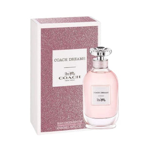 Coach Dreams perfume bottle positioned on the right in front of its elegant box on Fragrancedealz.com