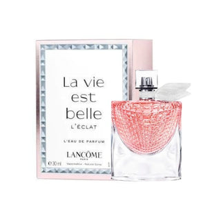 La Vie Est Belle L'eclat Perfume bottle delicately positioned in front of its luxurious box, capturing the essence of radiant beauty with its sparkling citrus, floral, and gourmand notes, available on Fragrancedealz.com