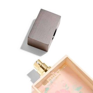 Joie De Vie Blush Perfume bottle on the floor, cap open, inviting indulgence and delight. Experience joy in every scent at fragrancedealz.com